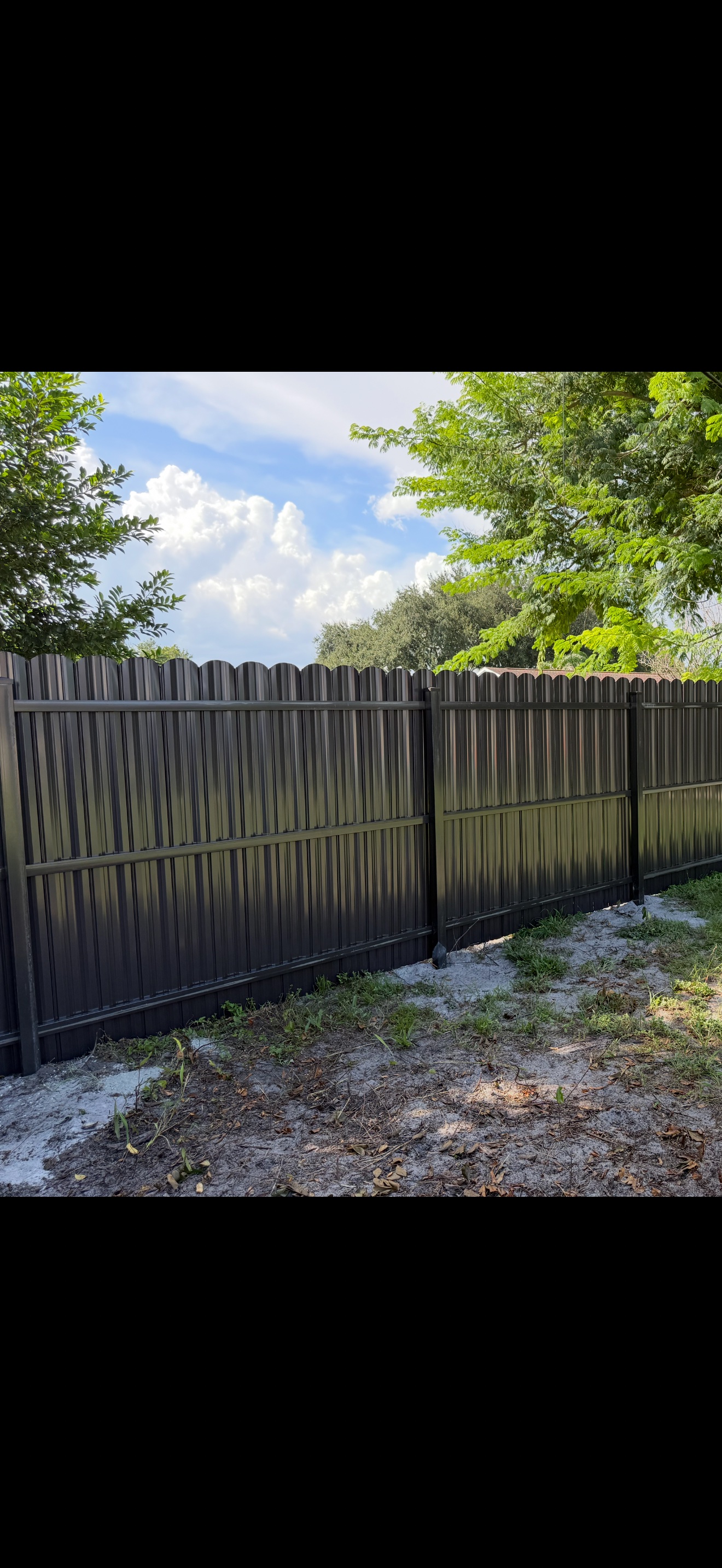 Bronze Dura-fence installation in a backyard