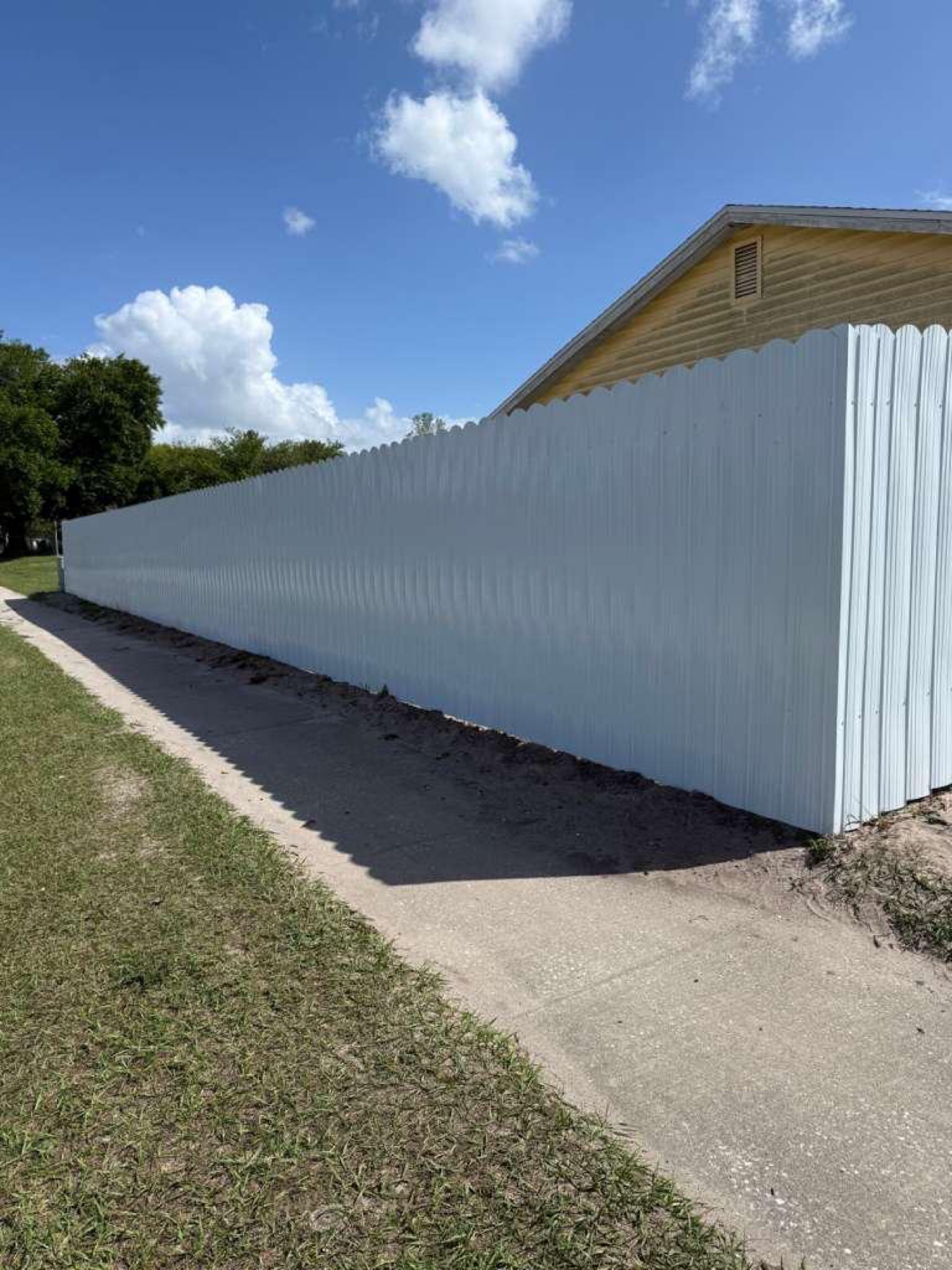 White Dura-fence installation along a home