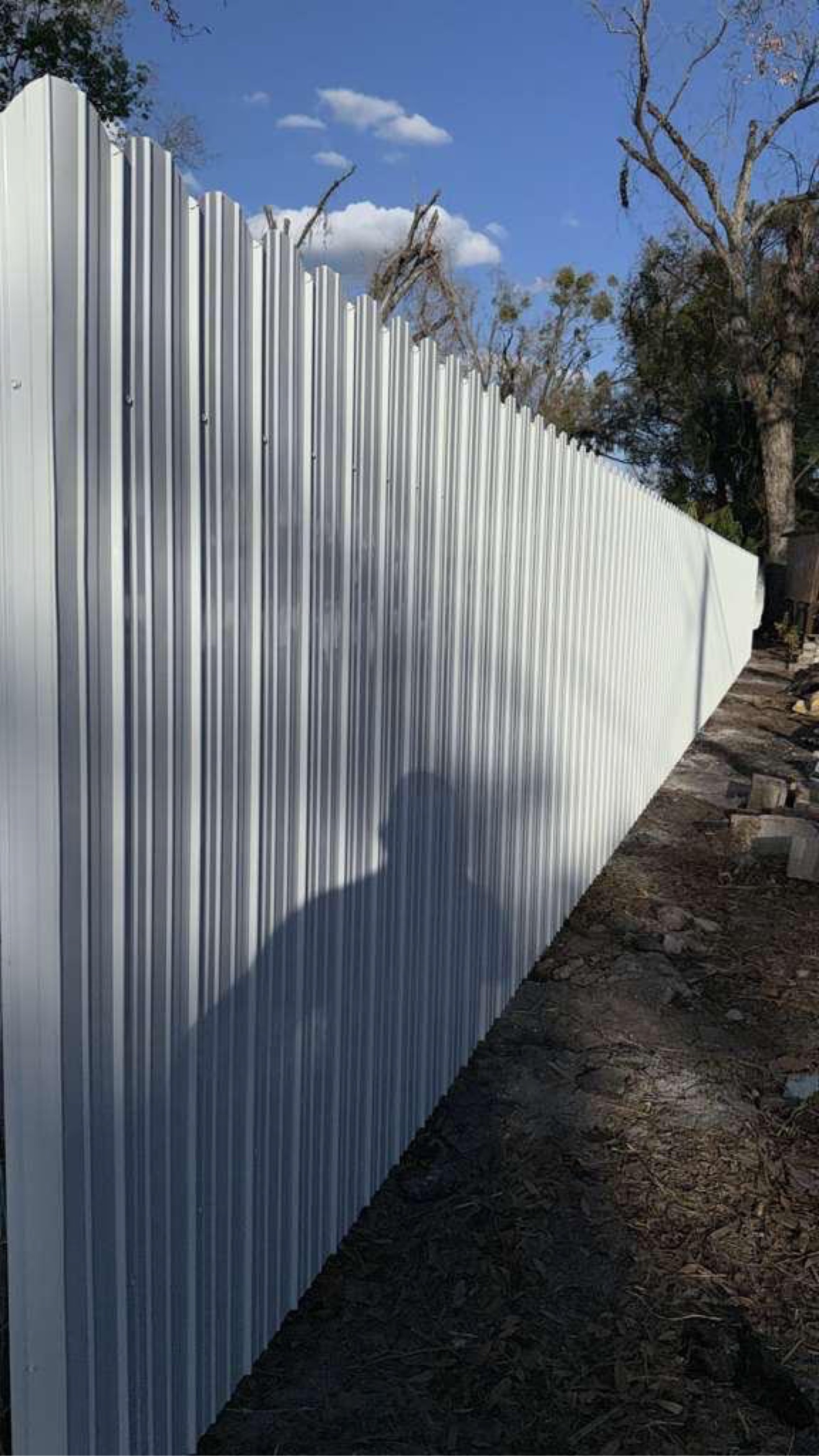 White Dura-fence installed around a residential yard