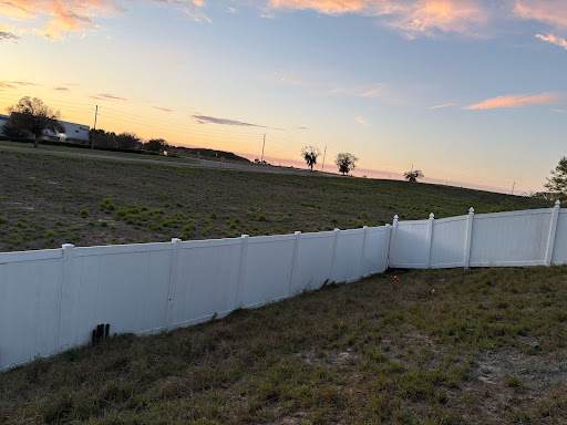 White vinyl privacy fence at sunset