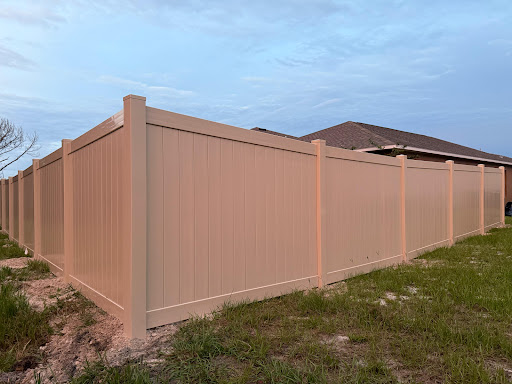 Tan vinyl privacy fence installed by Fort Fence Masters