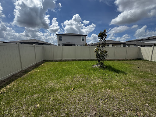 Tan vinyl privacy fence installed by Fort Fence Masters